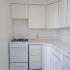 kitchen with white appliances and white cabinets