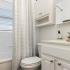 bathroom with one sink, shower, and toilet
