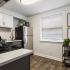 kitchen with stainless steel appliances and grey and white cabinets