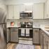 Kitchen with stainless steel appliances and grey and white cabinets