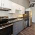 Kitchen with stainless steel appliances and grey and white cabinets