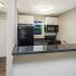 Kitchen with breakfast bar and black appliances