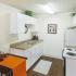 Kitchen with white appliances and white cabinetss