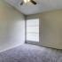 Bedroom with large window and ceiling fan