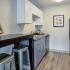 Kitchen with black appliances and white/grey cabinets