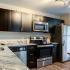Kitchen with stainless steel appliances and black cabinets