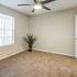 Bedroom with ceiling fan and large window