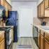 Kitchen with black appliances and wood cabinets