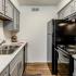 Kitchen with black appliances and grey cabinets