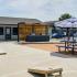 Outdoor grill and game area with picnic tables