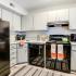 Kitchen with black appliances and grey cabinets