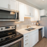 Kitchen with stainless steel appliances and white cabinets