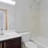 Bathroom with one sink, a shower, and toilet