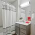 Bathroom with one sink, a shower, and toilet