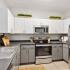 kitchen with stainless steel appliances and grey and white cabinets