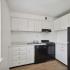 kitchen with black appliances and white cabinets