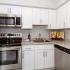 Cozy kitchen with stainless steel appliances, marble style counters, and lots of cabinets