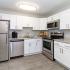Northgate Village apartment kitchen with white cabinets and stainless steel appliances