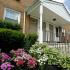 Exterior of residential buildings with blooming flowers and green shrubbery at Northgate Village apartments for rent