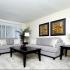 Furnished living room with grey couches, carpet flooring, and brown coffee table at Northgate Village apartments for rent in Burlington, NJ