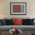 Living room with a grey couch, decorative pillows, and two side tables