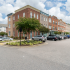 exterior apartment buildings with parking lot on sunny day