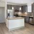 Modern kitchen with granite counters, island and LED lighting. | The Enclave at Mira Lagos  | Apartments Grand Prairie TX
