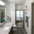 Modern bathroom with granite counters and plenty of storage | Enclave at Mira Lagos apartments in Grand Prairie TX