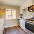 Kitchen with wooden floors, gas range and built-in microwave at our Walnut Creek apartments