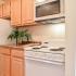 Applegate Apts; interior, kitchen, electric range, microwave with vent, maple cabinets, frost free fridge, GFI outlets