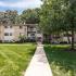 Americana Southdale Apts; exterior, walk way, manicured lawn, shrubs, trees, balconies, 3 story building