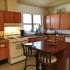 Kitchen with wood cabinets and small island table | Fort Hood Family Housing | killeen homes for rent