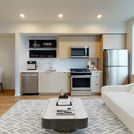 Spacious studio homes with built in shelves and galley kitchens at Modera Broadway Apartments