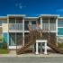 Belleza, exterior, blue and tan building, stairs to second level, patios and balconies,