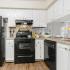 Fully Equipped Kitchen with dishwasher, oven, range, and refrigerator | Advenir at Walden Lake
