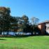 Gorgeous lakeside area with trees and grass outside of Lake Club Apartments