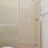 Bathroom with tiled walk-in stall shower at Norriton East Apartments in East Norriton, PA.