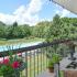 Beautiful balcony view of landscaped grounds and swimming pool from Main Line Berwyn Apartments