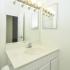 Quaint bathroom with white sink and vanity and large mirror