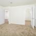 Spacious carpeted bedroom with large walk-in closet and window