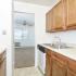 Model kitchen with tiled floors, wood cabinets and modern appliances at Woodland Plaza Apartments in Wyomissing, PA.