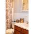 Bathroom with white sink and brown vanity and small medicine cabinet