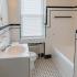 Bathroom with tiled flooring and a tile shower at Delfe Apartments at Trolley Square in Wilmington, DE