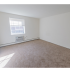 Spacious bedroom with plush carpeting and large windows at Evergreen Club apartments for rent in Broomall, PA