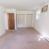 Large bedroom with baseboard heating and two closets at Evergreen Club apartments for rent in Broomall, PA