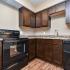kitchen with wood cabinets and hardwood floors at Silver Springs Apartments in Springfield MO
