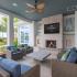 Artisan Living Bella Citta Rental Townhomes outdoor lounge with fireplace and television