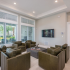 Artisan Living Bella Citta Rental Townhomes clubhouse lounge with seating and television