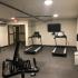 Draper Lofts Apartments, interior, fitness center, treadmills, elliptical, tv