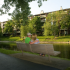 Residents Sitting on Bench Overlooking Lake and Apartment | Lake+House Apartments | Apartments In Wheeling IL